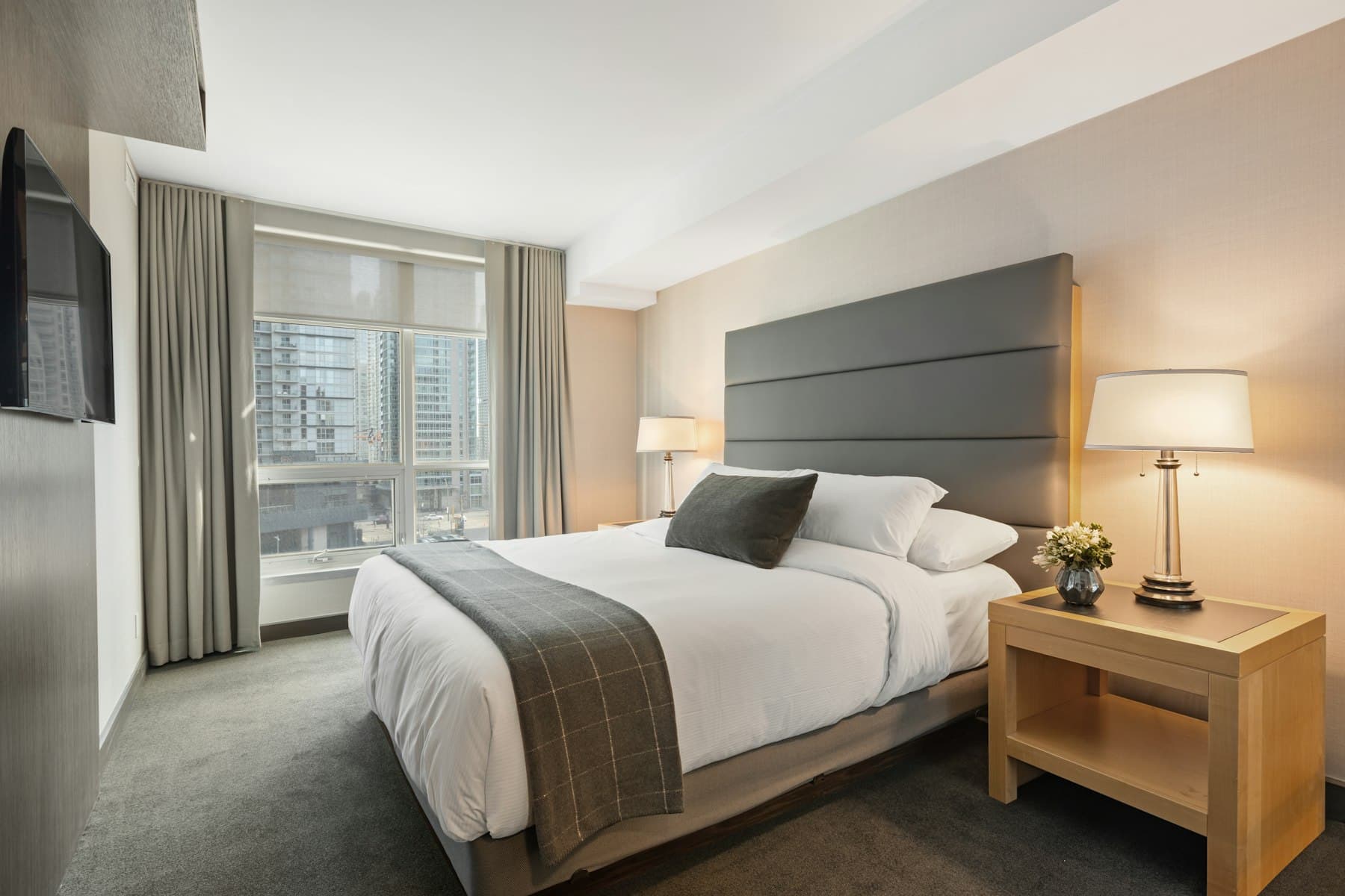 Neatly made double bed and mattress in a Dubai apartment bedroom
