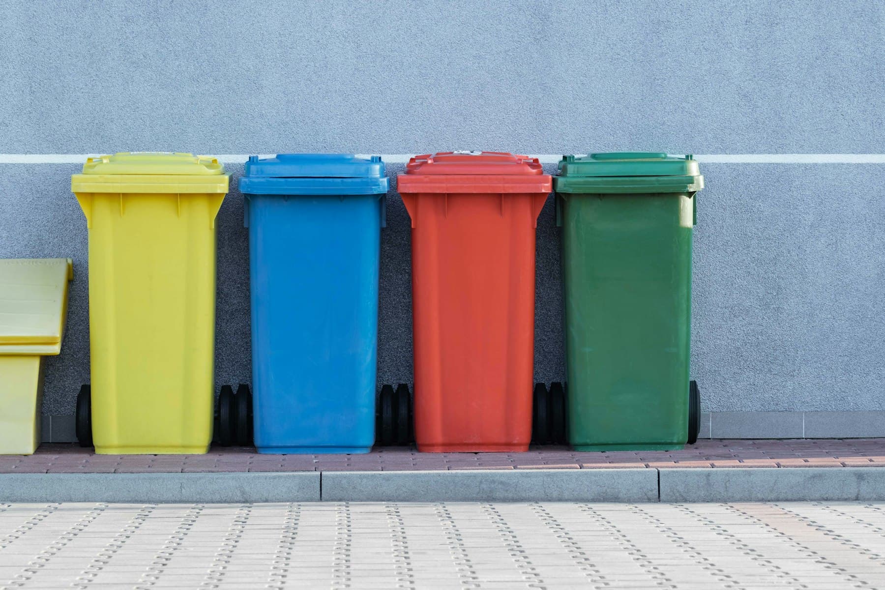 Colour-coded waste and recycling bins for sorted junk disposal